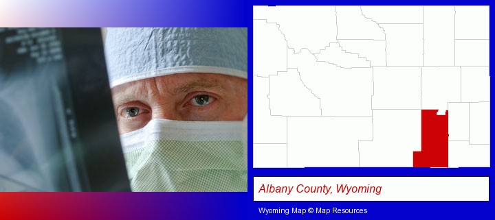 a physician viewing x-ray results; Albany County, Wyoming highlighted in red on a map