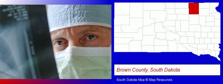 a physician viewing x-ray results; Brown County, South Dakota highlighted in red on a map